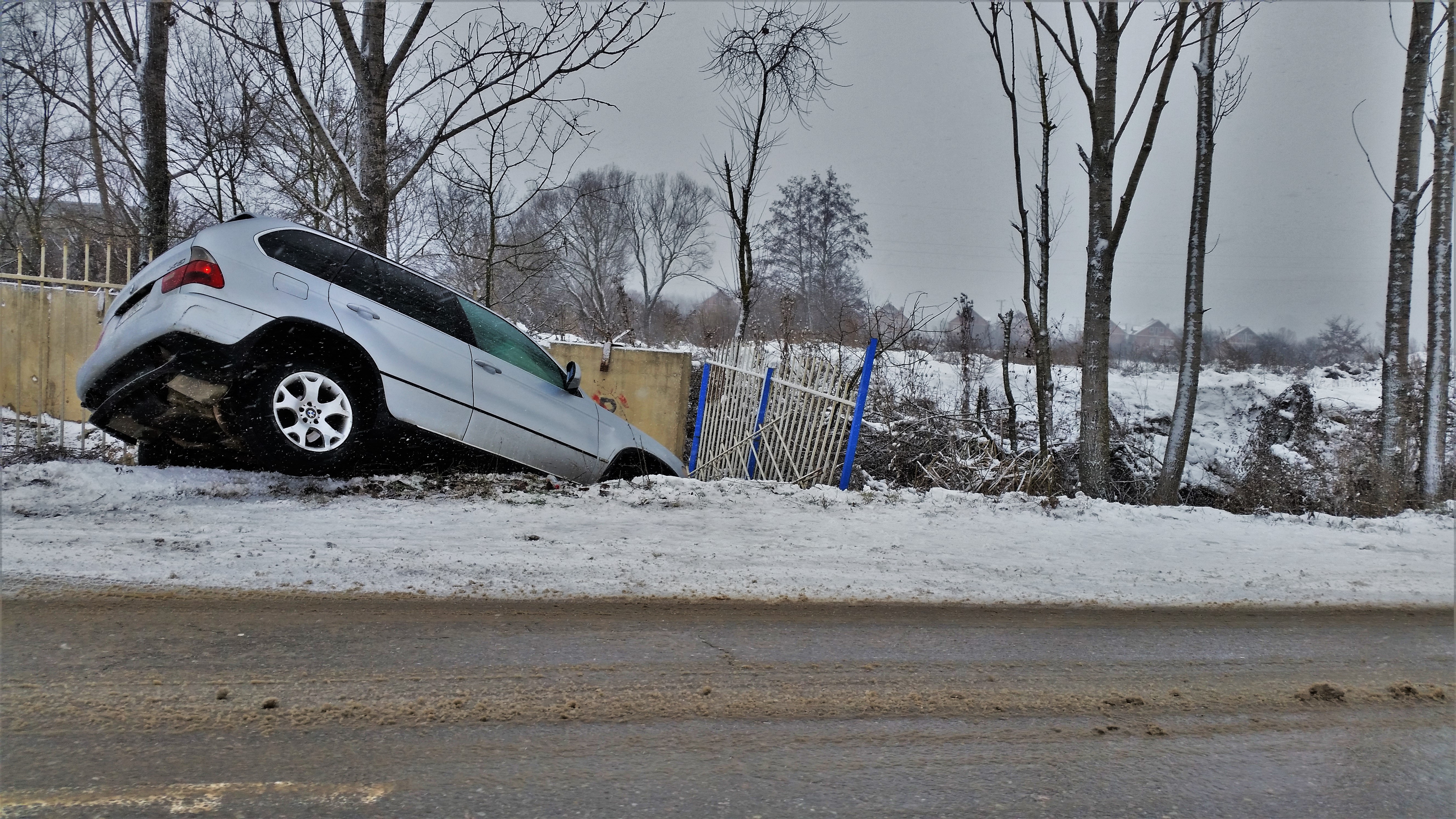 A car in the ditch having slid off a road because they did not consult Smoothly for a flatter way home.